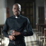 African priest in church