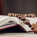 Bible and a crucifix on an old wooden table. Religion concept