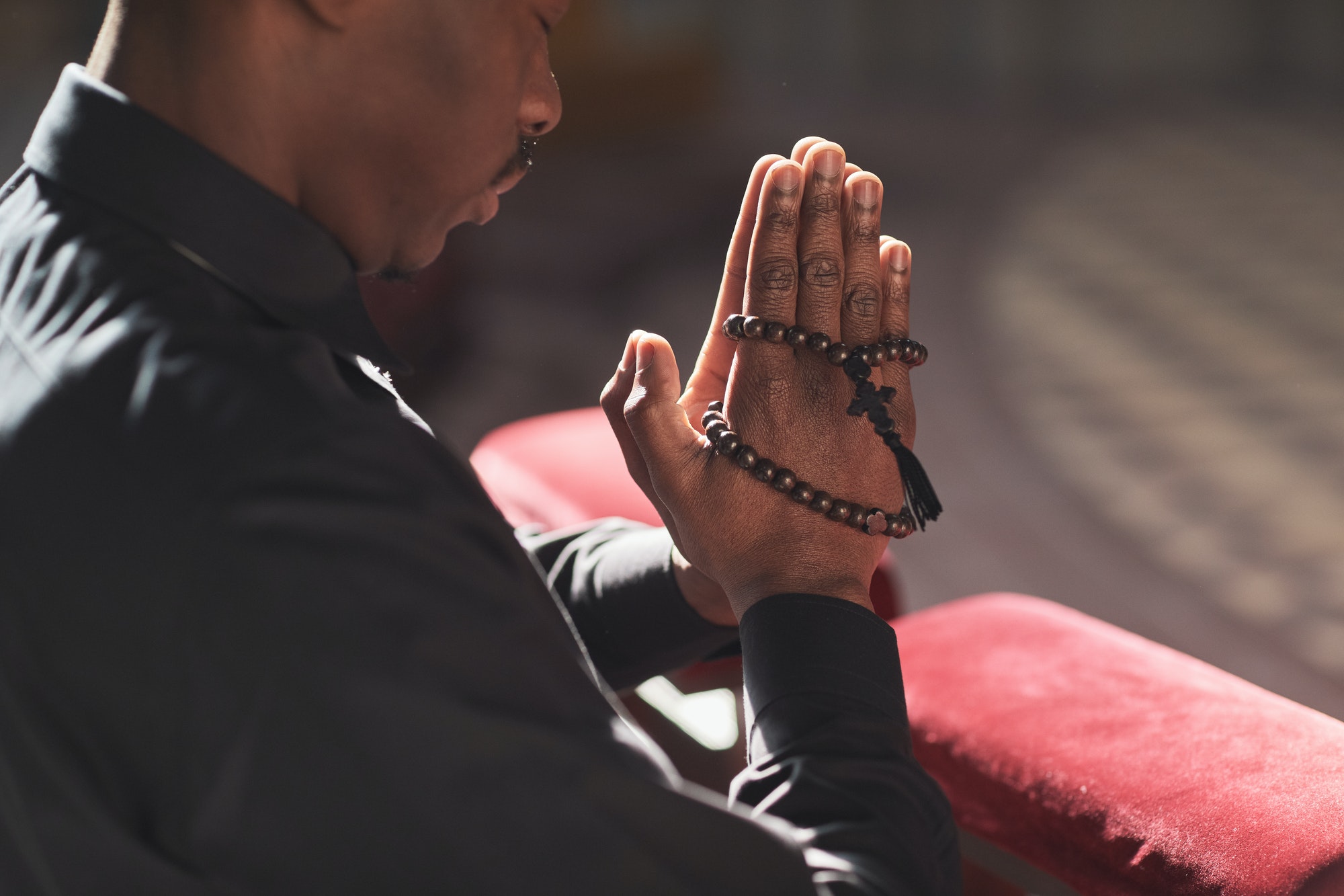 Catholic with rosary praying