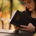 Christian teen girl holds bible in her hands. Reading the Holy Bible. Concept for faith
