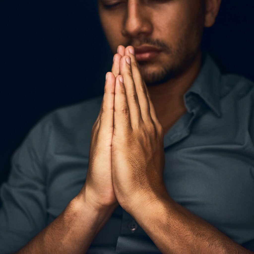 Give us this day our daily bread. Closeup shot of a young man praying with his eyes closed.