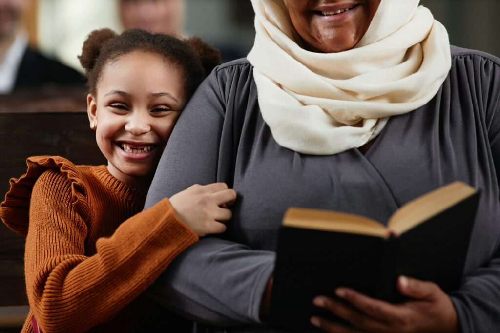 Grandmother with granddaughter visiting to church