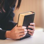 Portrait of a woman with bible prayers, spirituality and religion concepts.