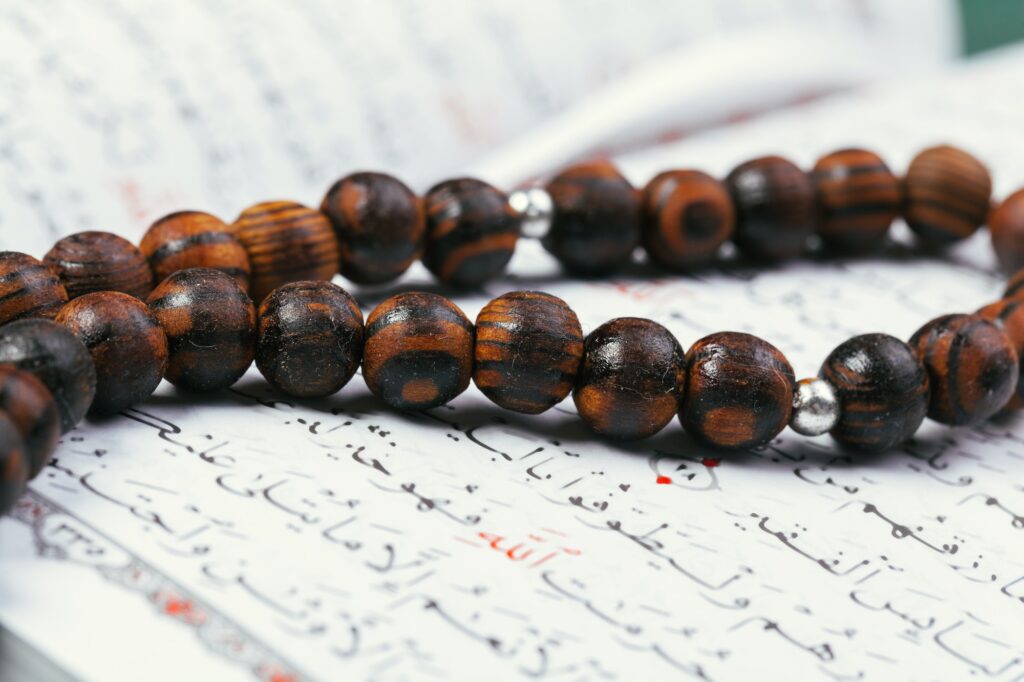 The Open holy Quran with tasbih/rosary beads close up