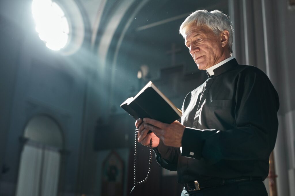 Senior priest with the Bible