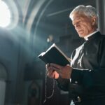 Senior priest with the Bible